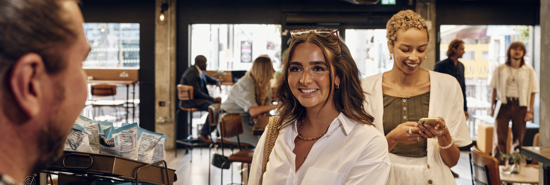 Customer paying with Santander International Gold Visa debit card at barista counter in Jersey Work Cafe