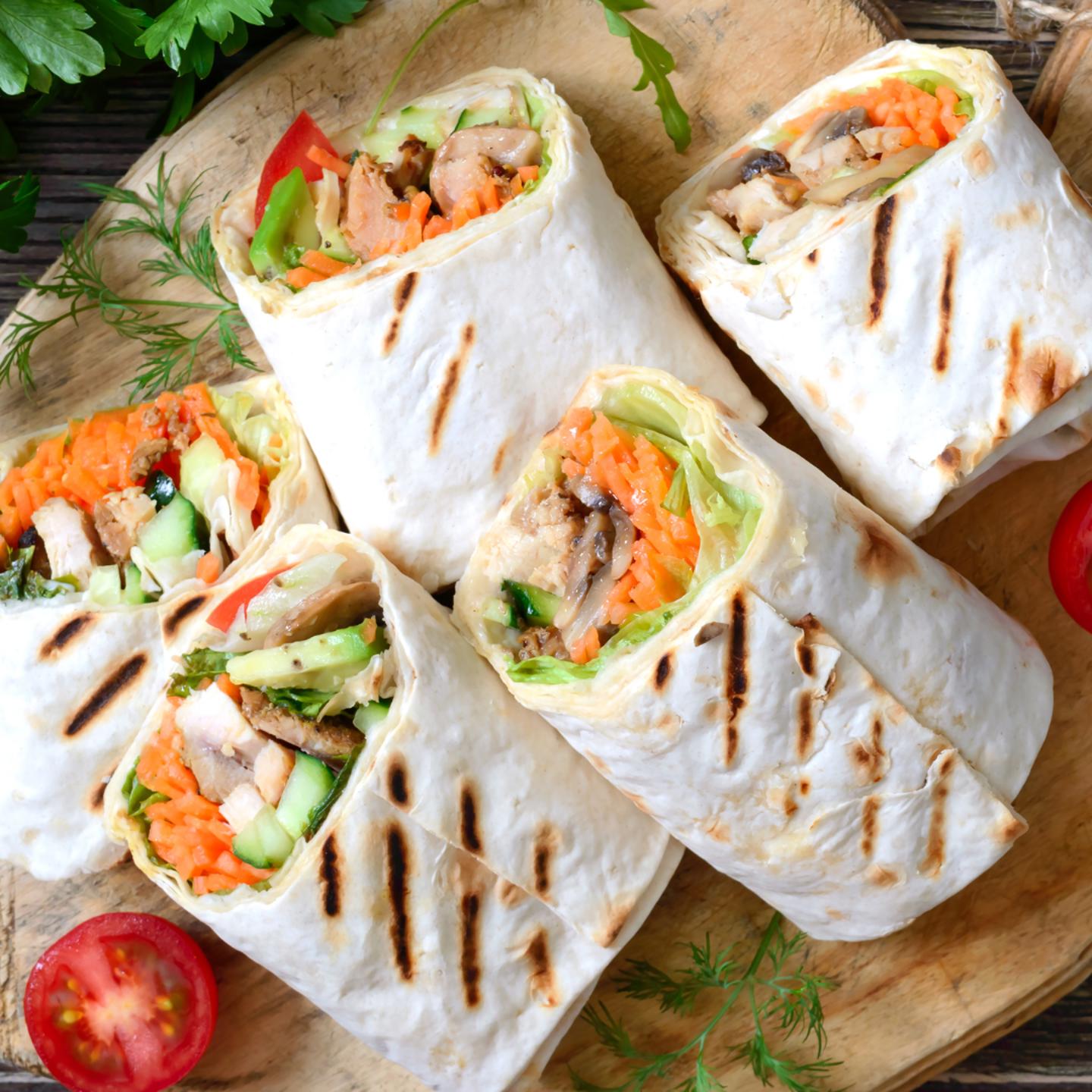 Chicken wraps on wooden board