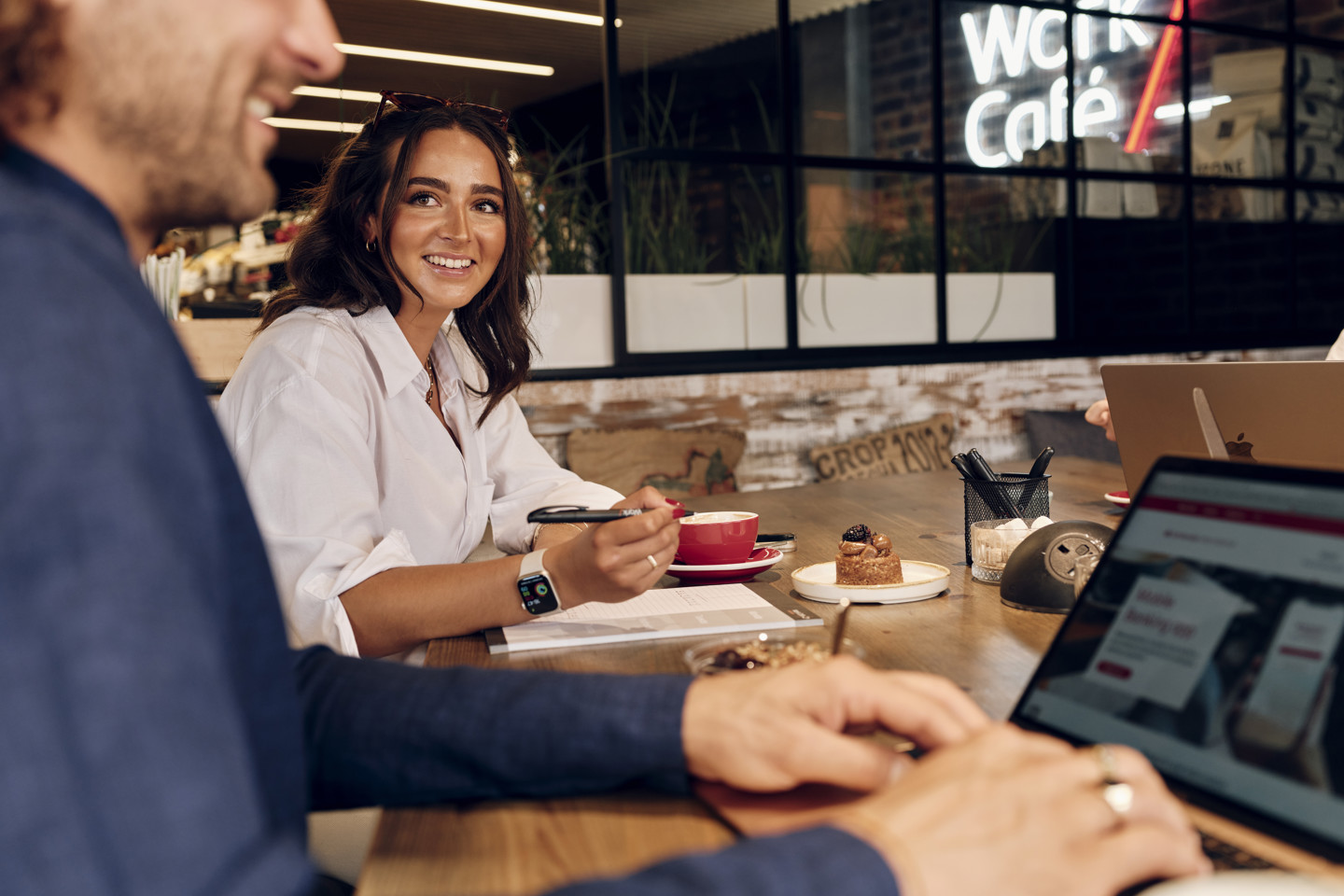 Couple meeting in Jersey Work Cafe with lap tops, coffee and pastries
